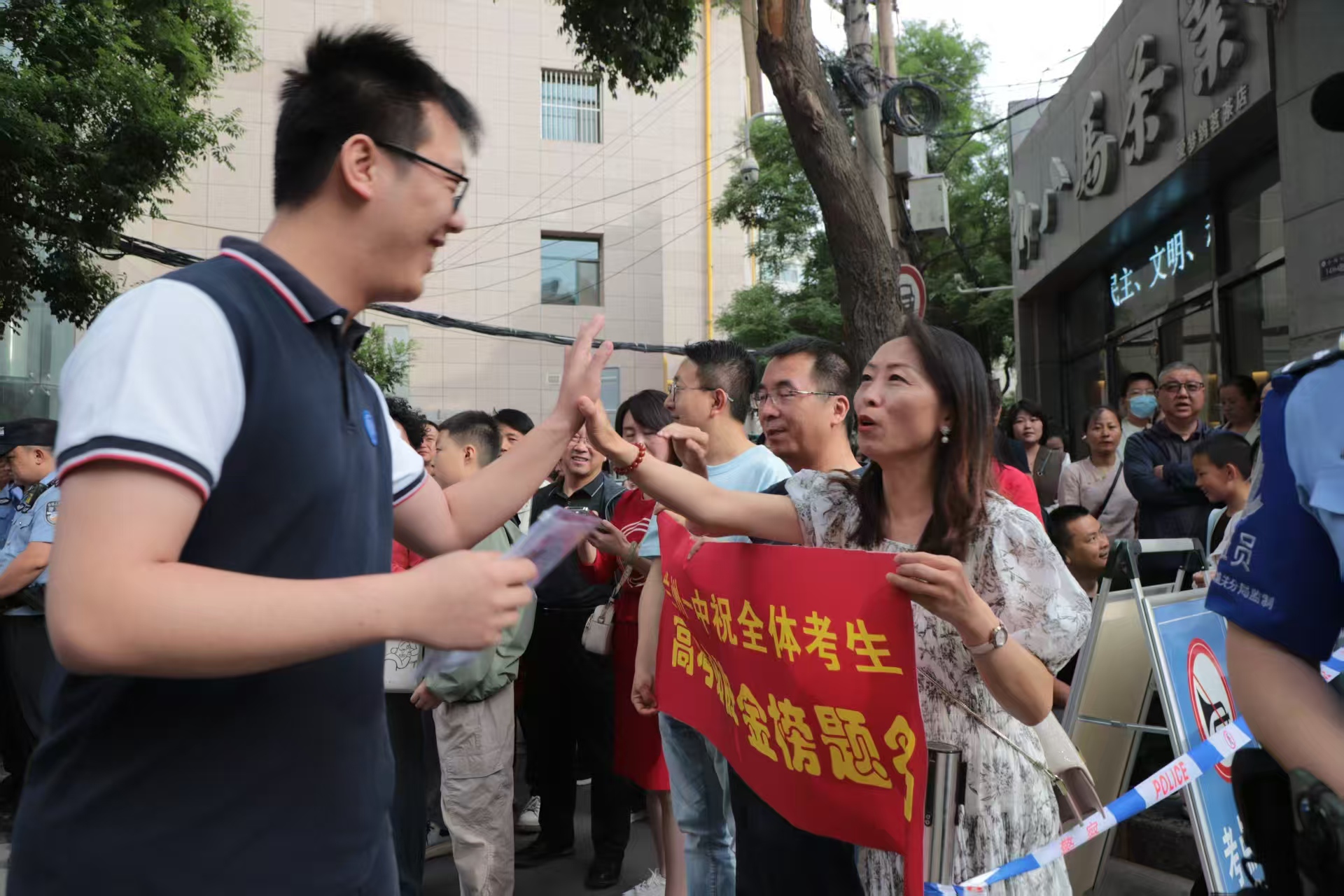 首場考試開考前，蘭州一中教師在考場外暖心陪考送祝福，鼓勵(lì)學(xué)生從容應(yīng)對。（馬綺徽 攝）.jpg